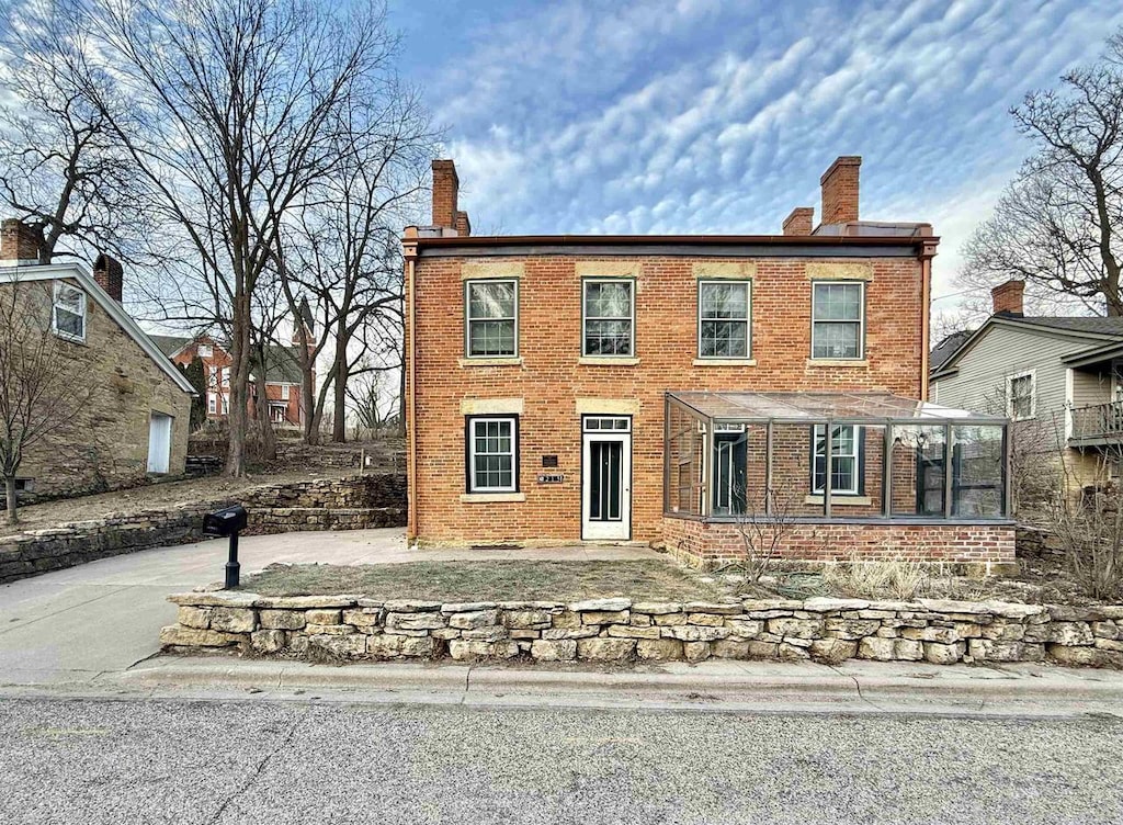 colonial home featuring a sunroom