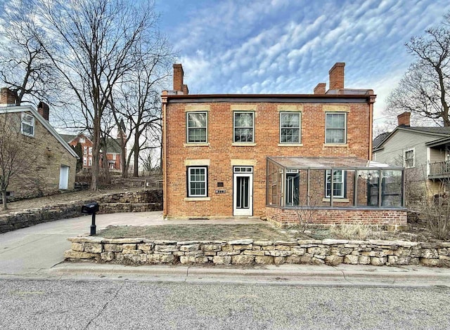 colonial home featuring a sunroom