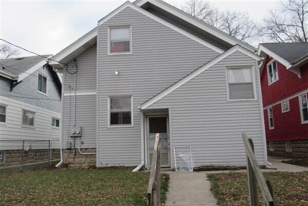 rear view of house with a yard