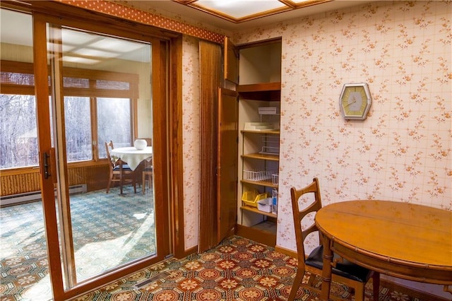 dining room featuring baseboard heating and a wealth of natural light