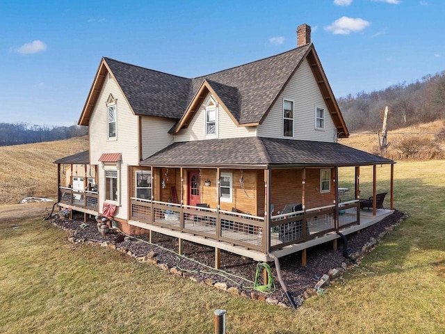 rear view of property with a yard