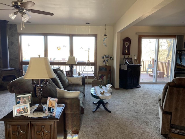 living room with ceiling fan and carpet