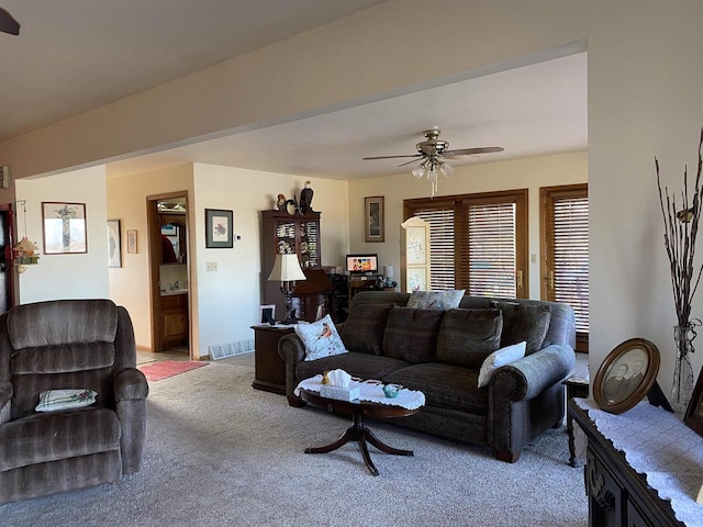 carpeted living room with ceiling fan