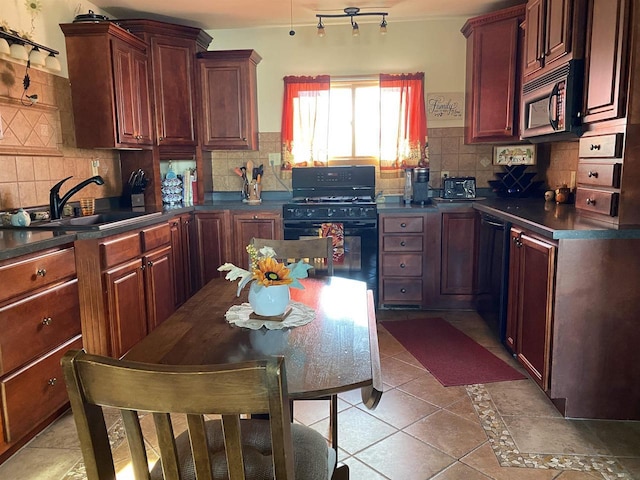 kitchen with backsplash, sink, light tile patterned floors, and black appliances