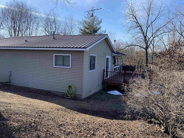 view of property exterior featuring a wooden deck