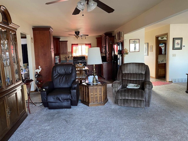 living room featuring ceiling fan and carpet floors