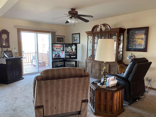 carpeted living room with ceiling fan