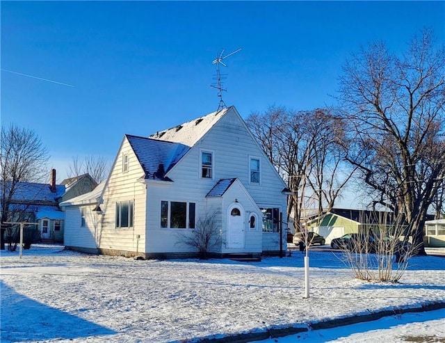 view of snow covered rear of property