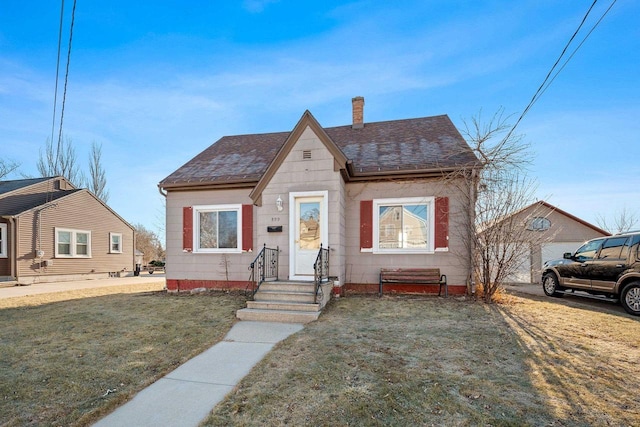 bungalow-style house with a front lawn