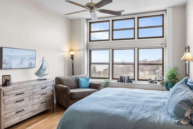 bedroom featuring light hardwood / wood-style floors and ceiling fan