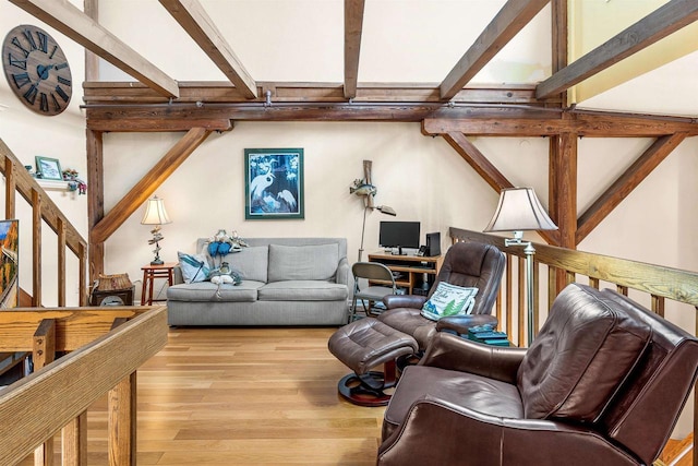 living room featuring beam ceiling and light wood-type flooring