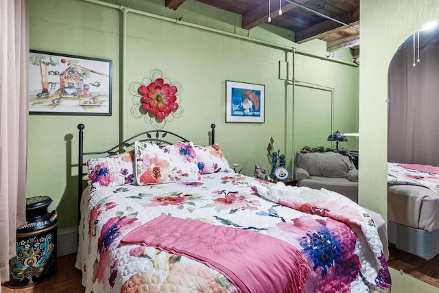 bedroom with beam ceiling, wooden ceiling, and parquet flooring