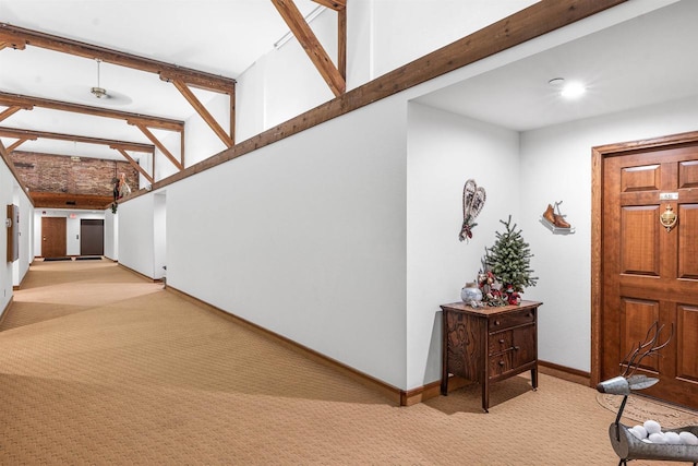 carpeted foyer entrance with lofted ceiling with beams