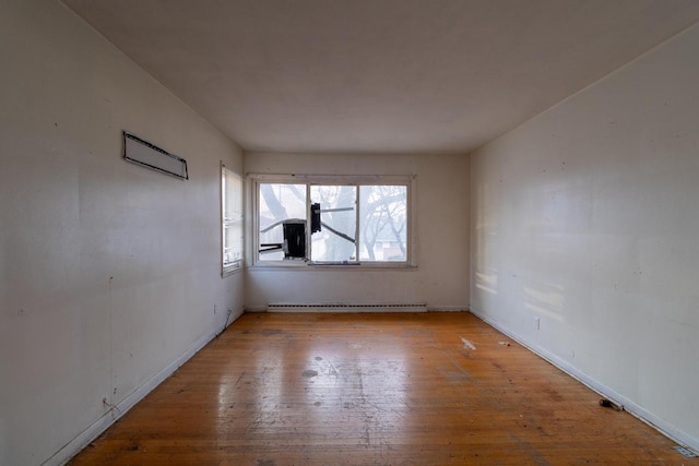 spare room featuring light hardwood / wood-style flooring and baseboard heating