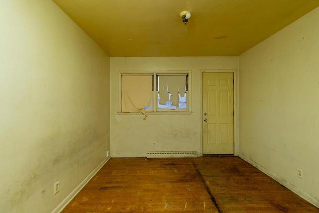 foyer entrance with baseboard heating and hardwood / wood-style flooring