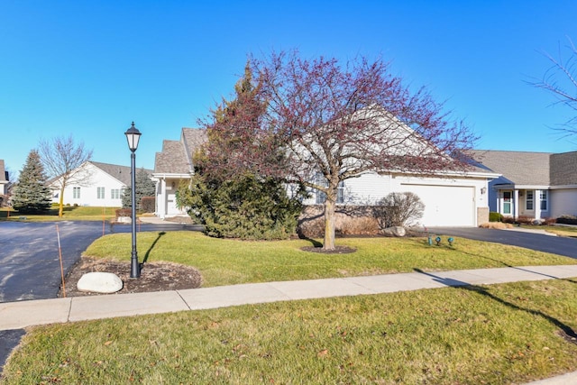 view of front of home with a garage and a front lawn