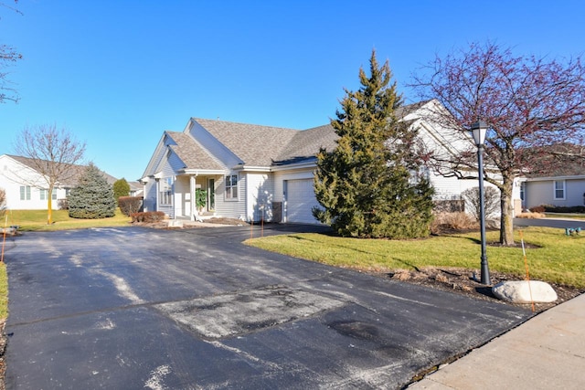 view of front of home with a front yard and a garage