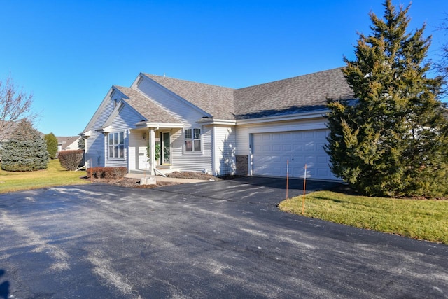 ranch-style house with a garage and a front lawn