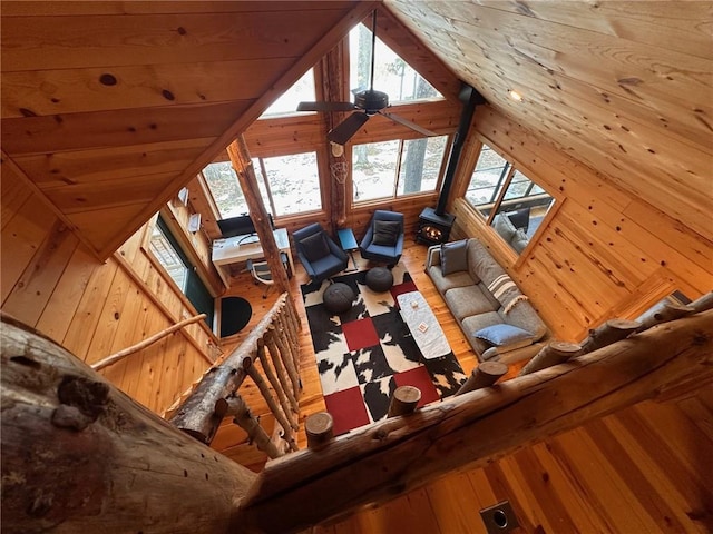 unfurnished living room with ceiling fan, hardwood / wood-style floors, wooden ceiling, and vaulted ceiling