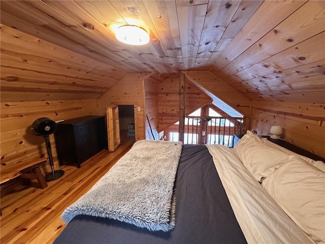 bedroom with wood-type flooring, wooden walls, vaulted ceiling, and wooden ceiling