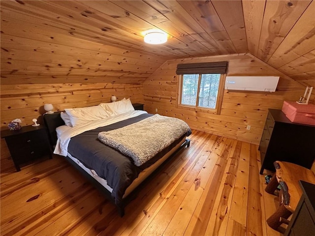 bedroom featuring light hardwood / wood-style floors, vaulted ceiling, wood walls, and wood ceiling