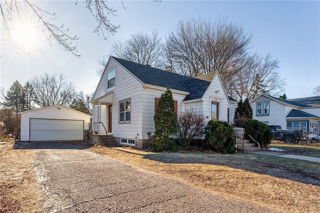 view of front of home with a garage and an outdoor structure