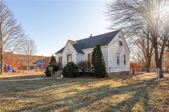 view of front of property with a playground and a front yard