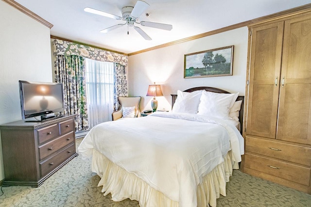 carpeted bedroom featuring ceiling fan and crown molding