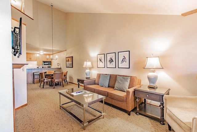 carpeted living room with a high ceiling and a notable chandelier