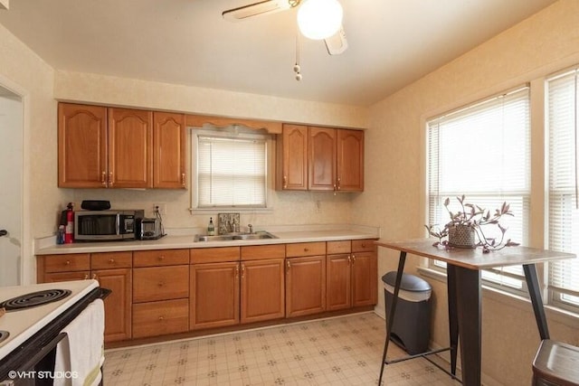 kitchen with ceiling fan, white electric range, and sink