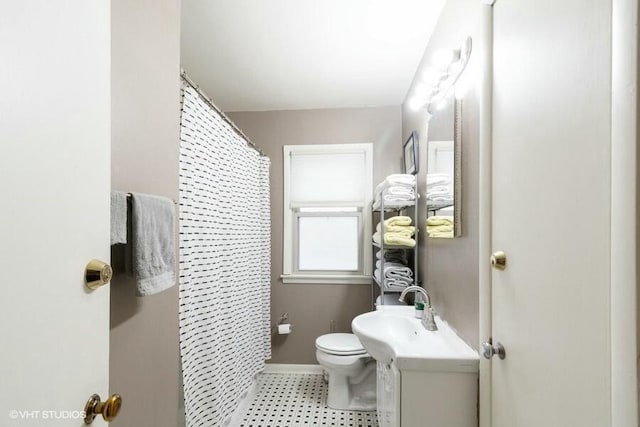 bathroom featuring vanity, toilet, and walk in shower