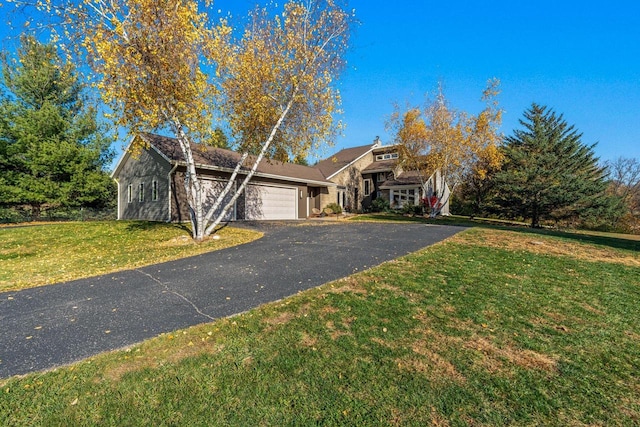 view of front of house featuring a front yard and a garage