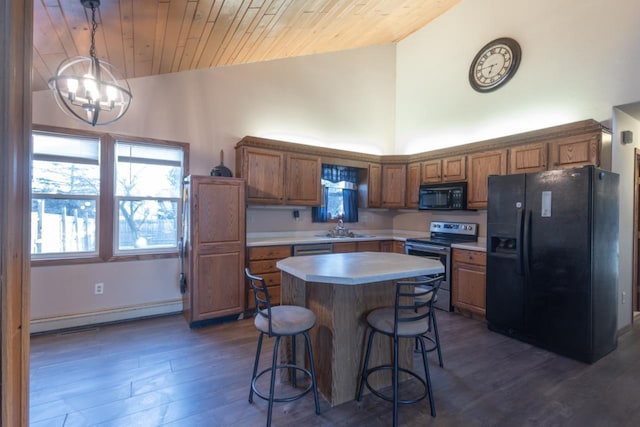 kitchen with pendant lighting, a center island, wooden ceiling, black appliances, and baseboard heating