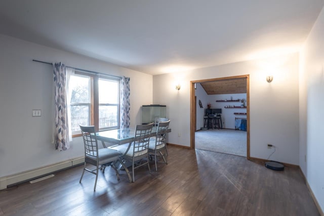 dining room with baseboard heating and dark wood-type flooring