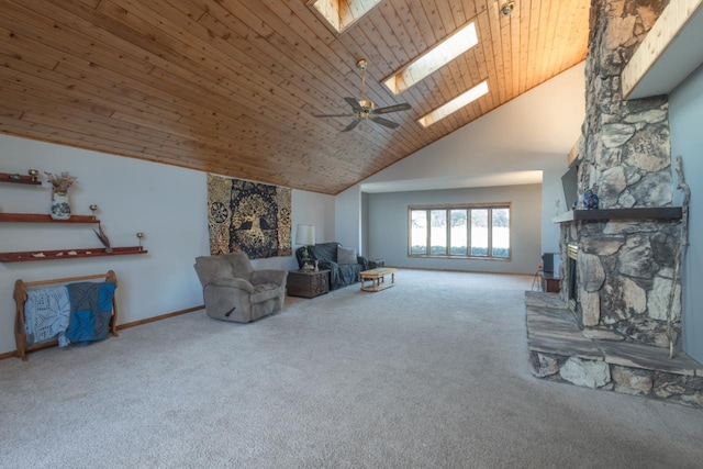 carpeted living room featuring a skylight, ceiling fan, a stone fireplace, high vaulted ceiling, and wood ceiling