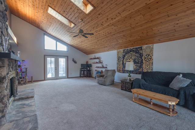 carpeted living room with french doors, a skylight, wood ceiling, ceiling fan, and high vaulted ceiling