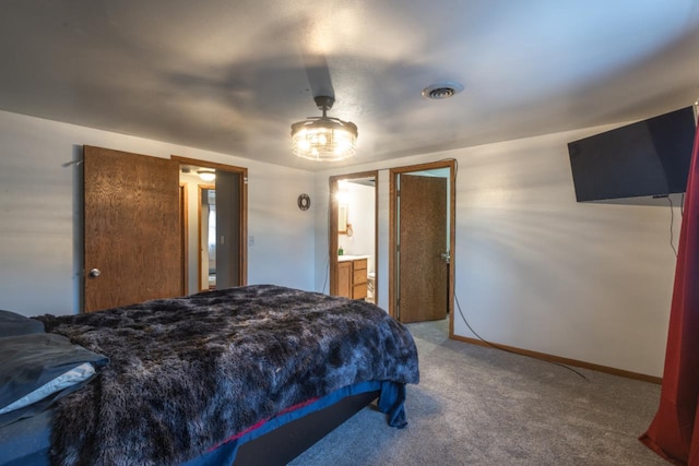 bedroom featuring ensuite bathroom, ceiling fan, and carpet floors