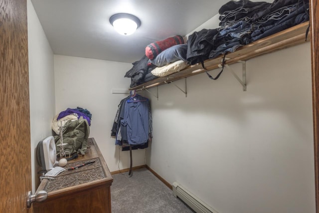 spacious closet featuring carpet and a baseboard heating unit