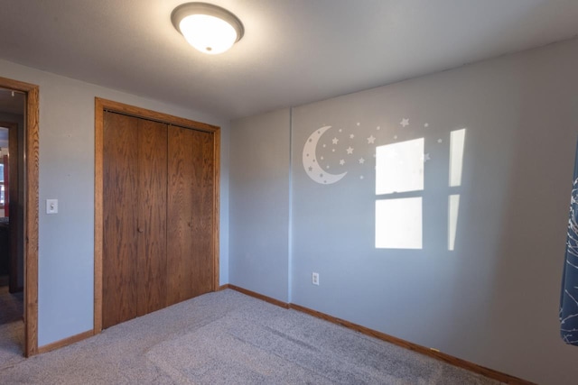 unfurnished bedroom with carpet floors and a closet