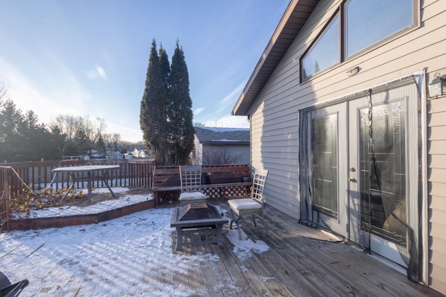 snow covered deck featuring an outdoor fire pit