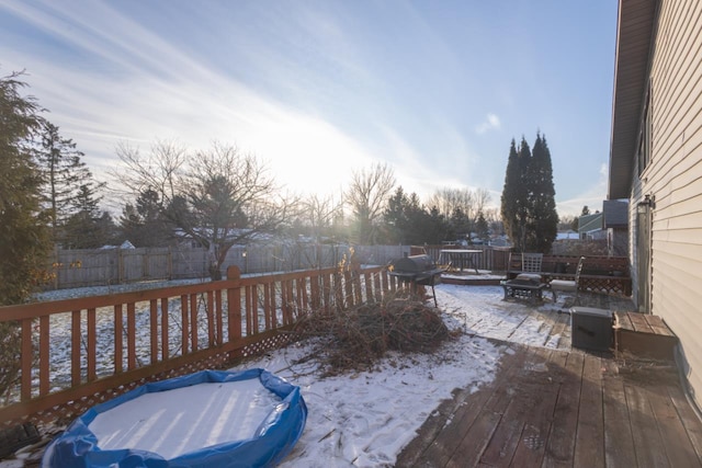 snow covered deck with a fire pit