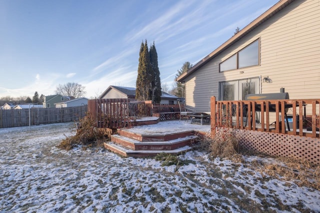 yard layered in snow featuring a wooden deck