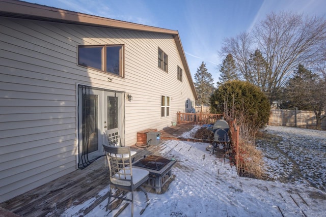 snow covered house with a deck