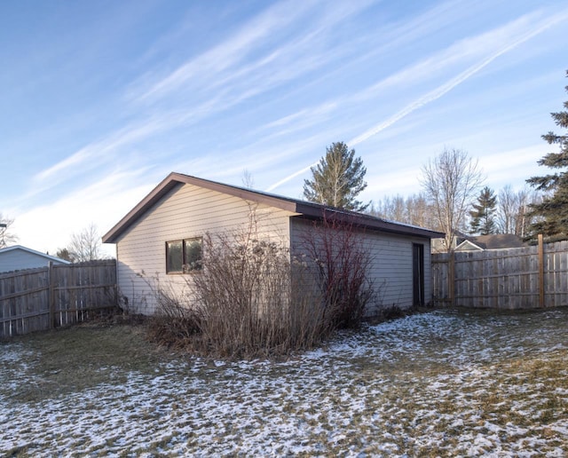 view of snow covered rear of property