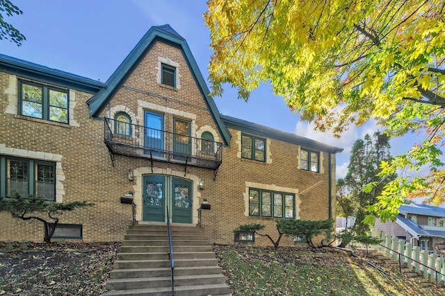 tudor-style house featuring a balcony