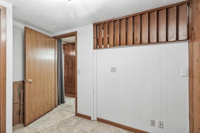 hallway with wood walls