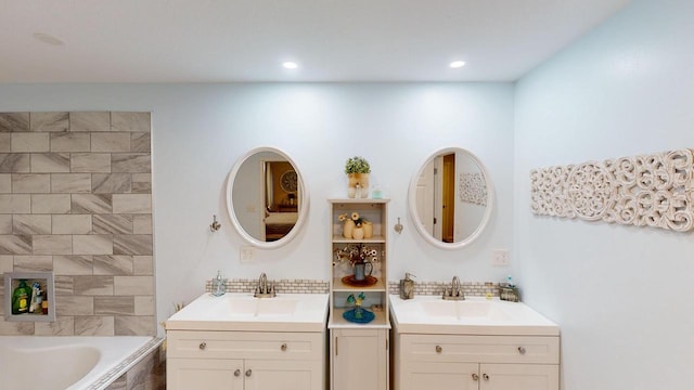 bathroom featuring vanity and tiled tub