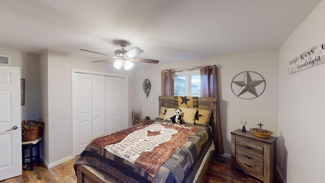 bedroom with dark hardwood / wood-style flooring, a closet, and ceiling fan