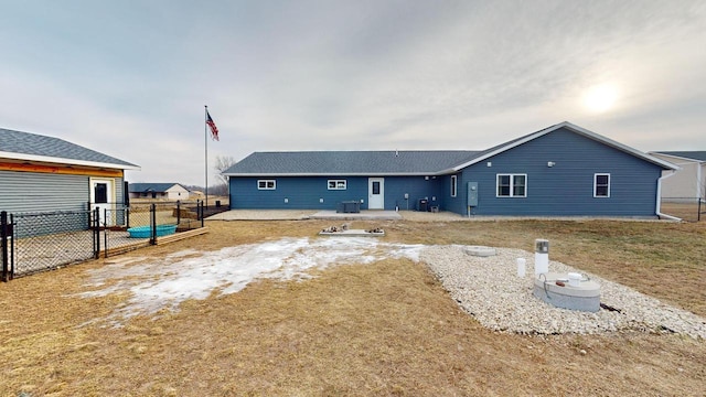 rear view of property with a lawn