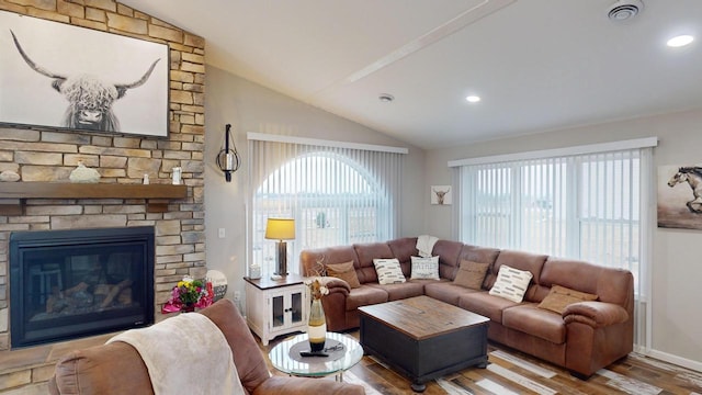 living room with a fireplace, wood-type flooring, and vaulted ceiling